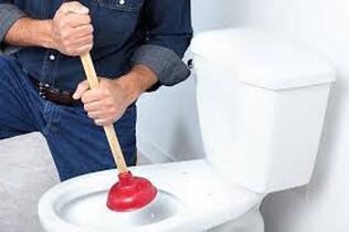 man plunging toilet 