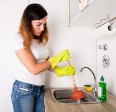 Woman unclogging sink