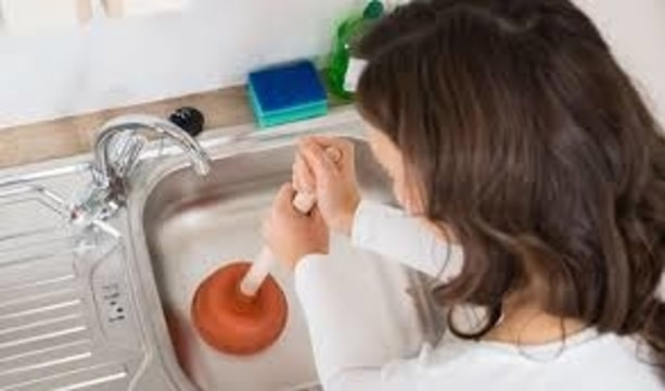 woman plunging sink
